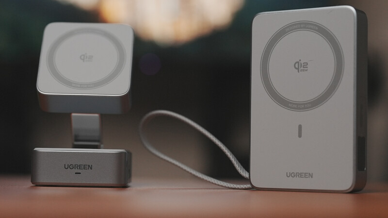 Three wireless charging devices by Ugreen arranged on a wooden surface with warm ambient lighting in the background.