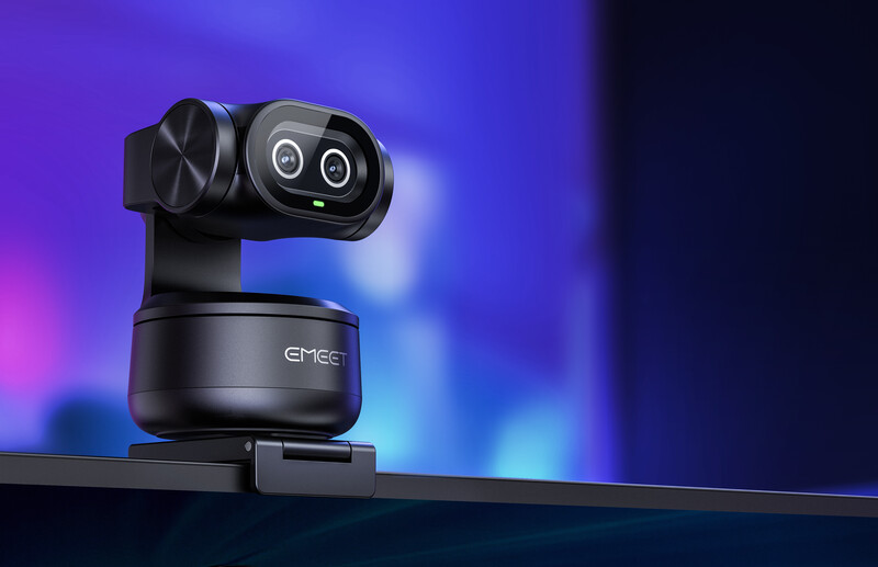 Compact robotic camera with dual rotating lenses mounted on articulating base against purple and blue gradient backdrop.