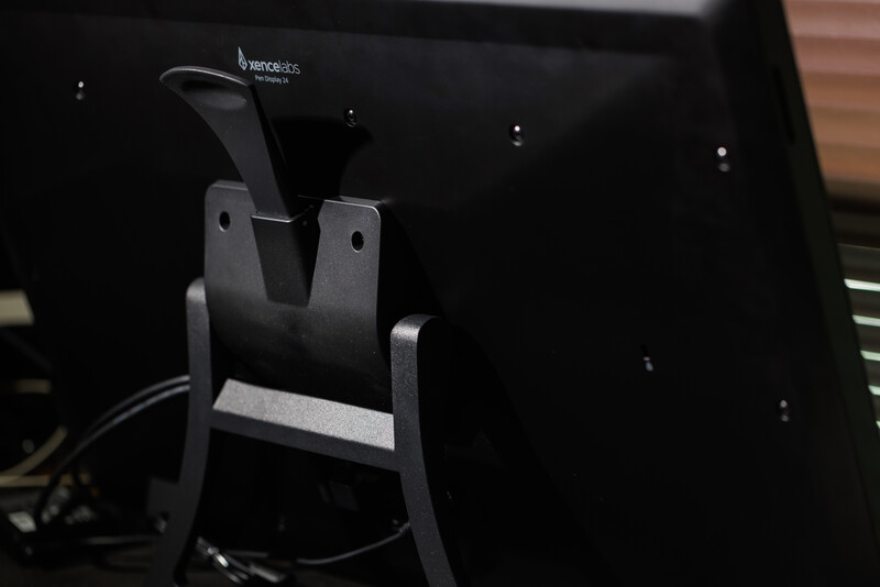 Close-up of a monitor arm clamp attachment mounted on the back of a display.