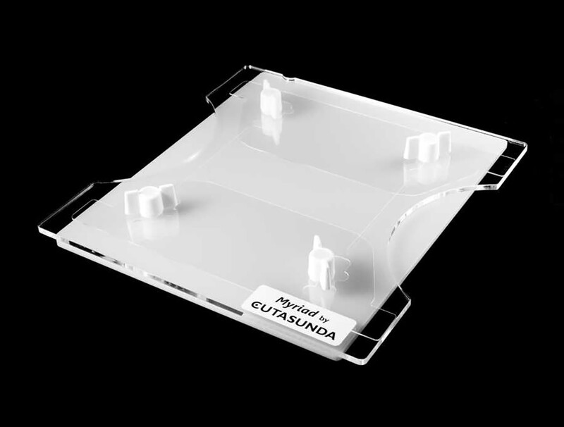 Clear acrylic product packaging box with black handles and white interior dividers on black background.