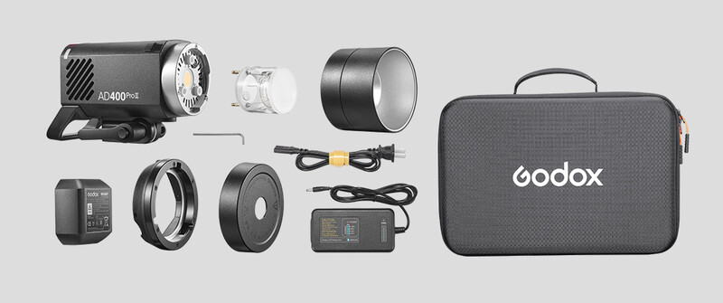 Godox AD400Pro flash kit with accessories including light heads, reflectors, power supply, cables, and carrying case.