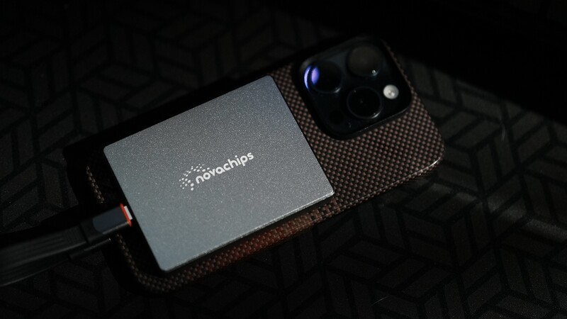 Smartphone with attached macro lens adapter from Neochips displayed against dark patterned background.
