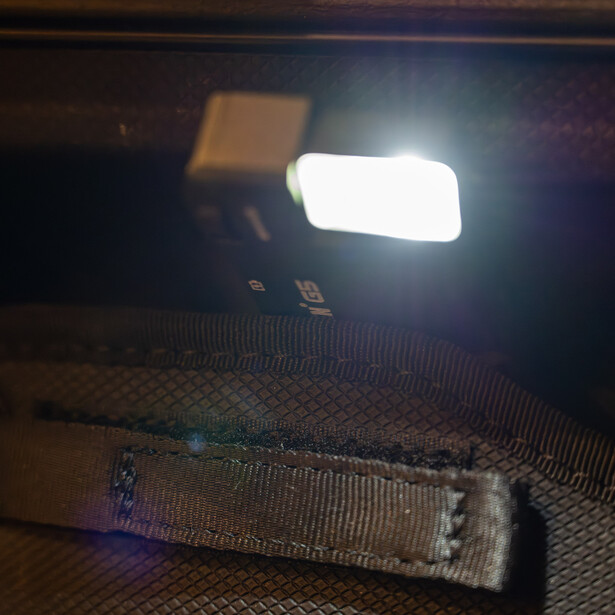 LED panel light positioned above fabric material during nighttime testing or setup.