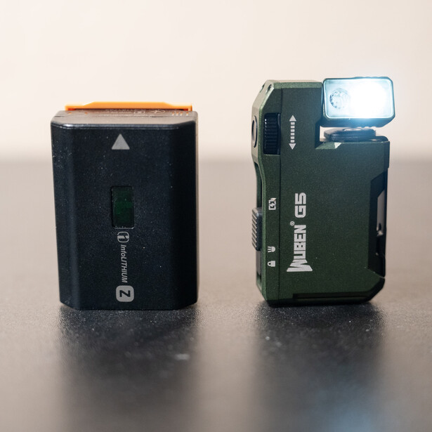 Two compact digital cameras photographed side by side against a neutral background.