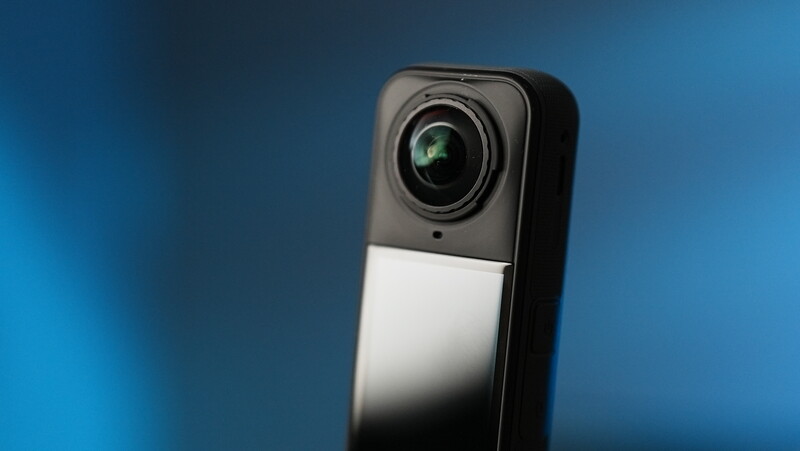 Smartphone accessory with dual-lens camera module mounted on upper portion against blue background.