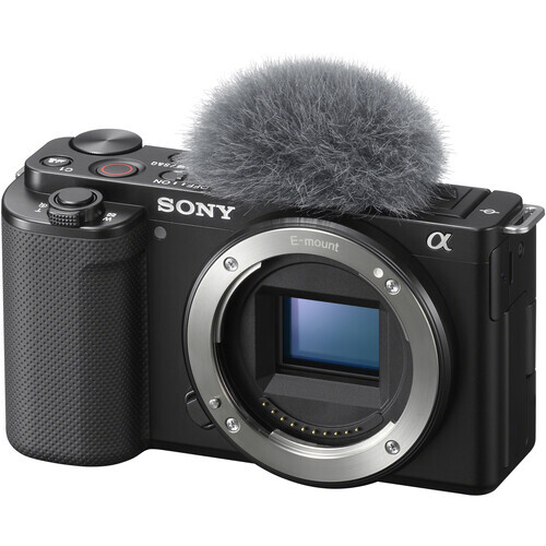 Sony Alpha mirrorless camera body with attached shotgun microphone against white background.