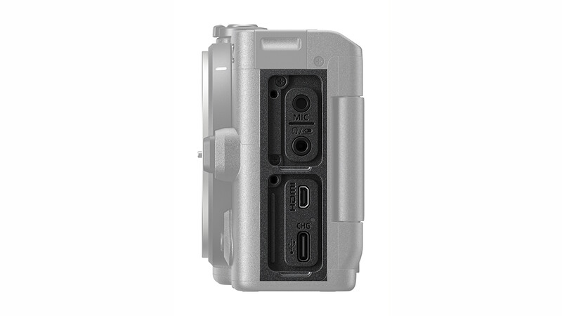 Side view of a compact camera showing ports and controls including USB-C, HDMI, and microphone inputs.