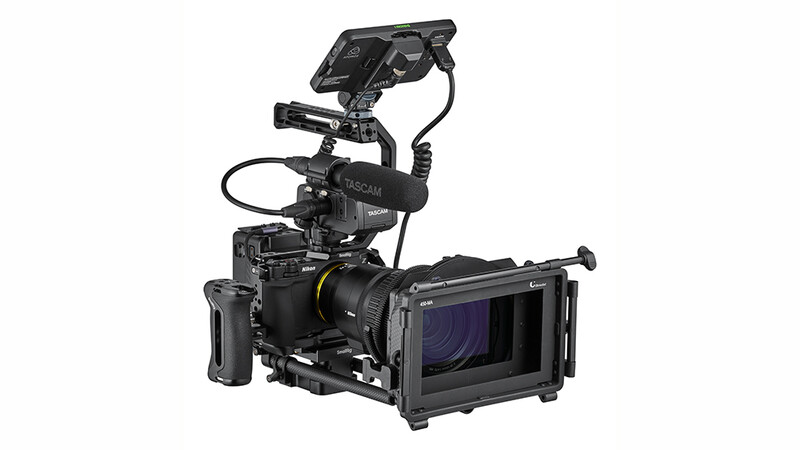 Professional cinema camera rig with monitor, lens, and shoulder support assembled on black frame.