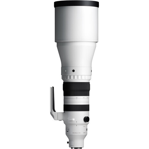 White and black telephoto lens with extended barrel and focus ring against white background.