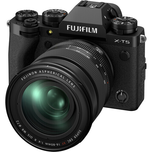 Fujifilm X-T5 mirrorless camera with attached Fujinon lens, shown in three-quarter front view against white background.
