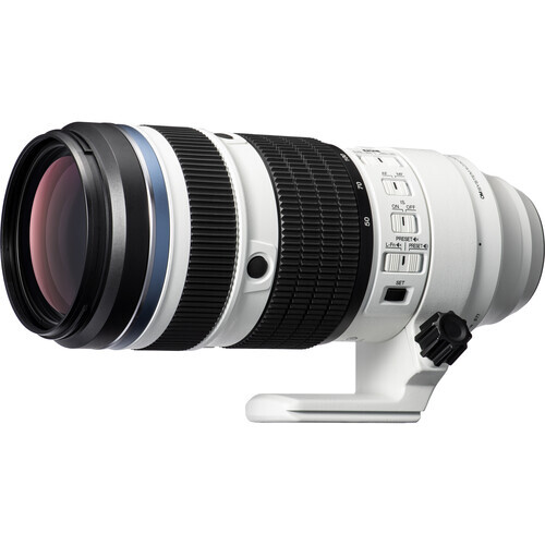White telephoto lens with black and white barrel bands and focus ring against white background.