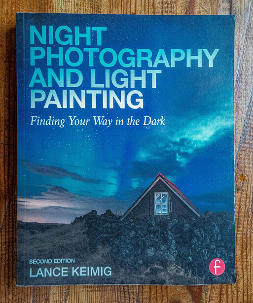 Book cover for Night Photography and Light Painting, Second Edition by Lance Keimig, featuring a house with lit windows against a twilight sky.