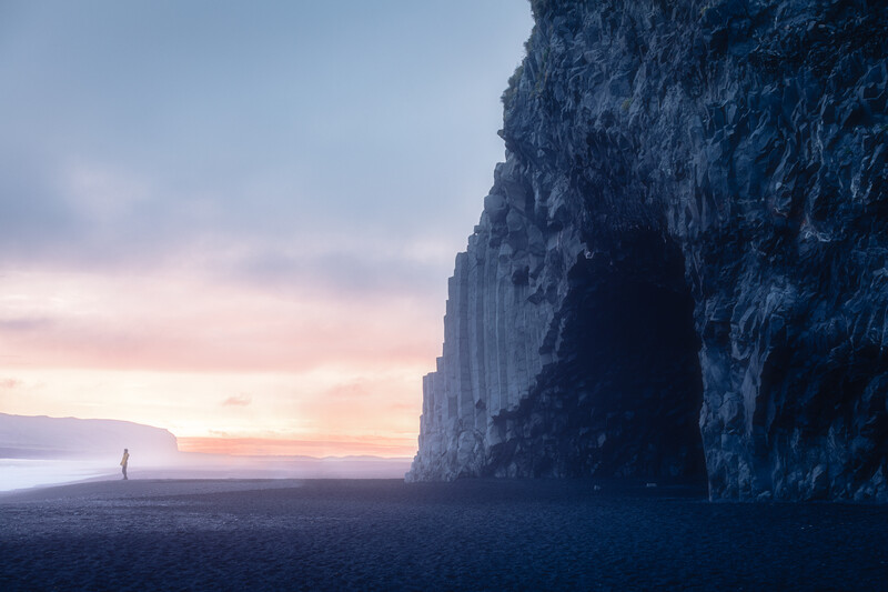 A human figure in front of the&nbsp;Halsanefshellir Cave, South Iceland at sunset