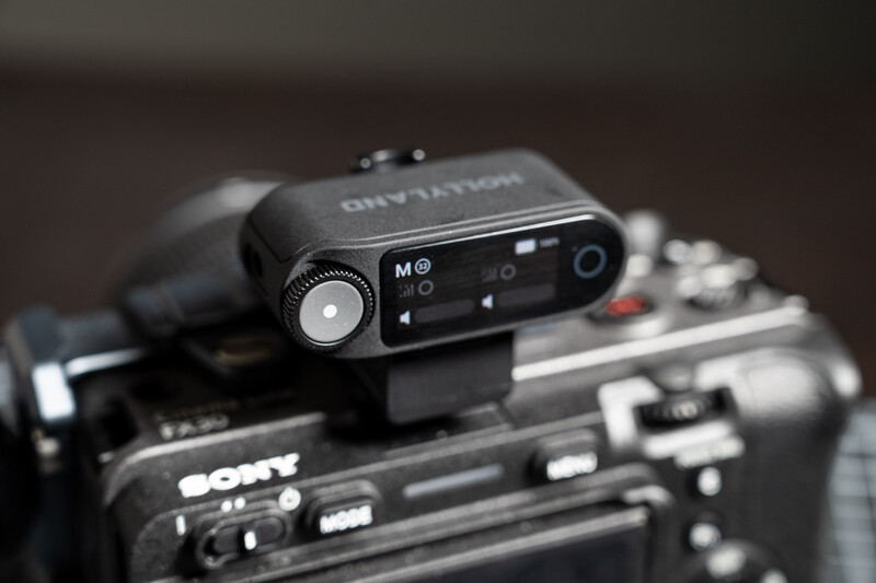 Compact microphone mounted on top of a Sony camera body, showing professional audio recording setup.