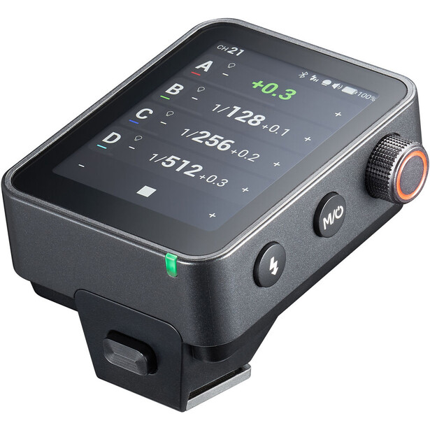 Compact wireless flash trigger or transmitter with digital display screen showing exposure settings and controls.