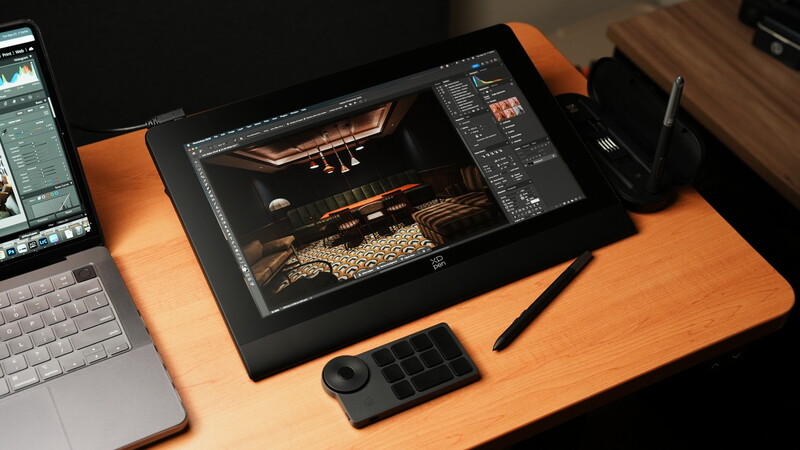 Professional photo editing workspace with pen display tablet showing wildlife image in editing software.