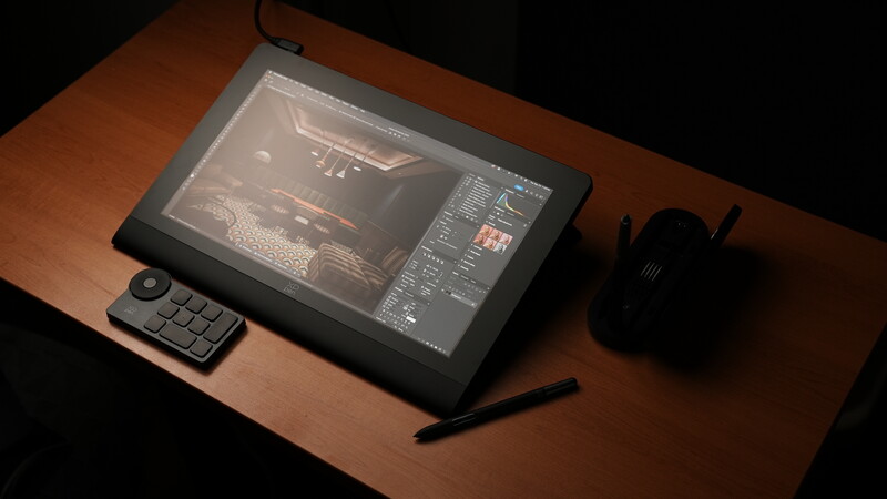 Digital tablet displaying video editing software with control panel and stylus on wooden desk.