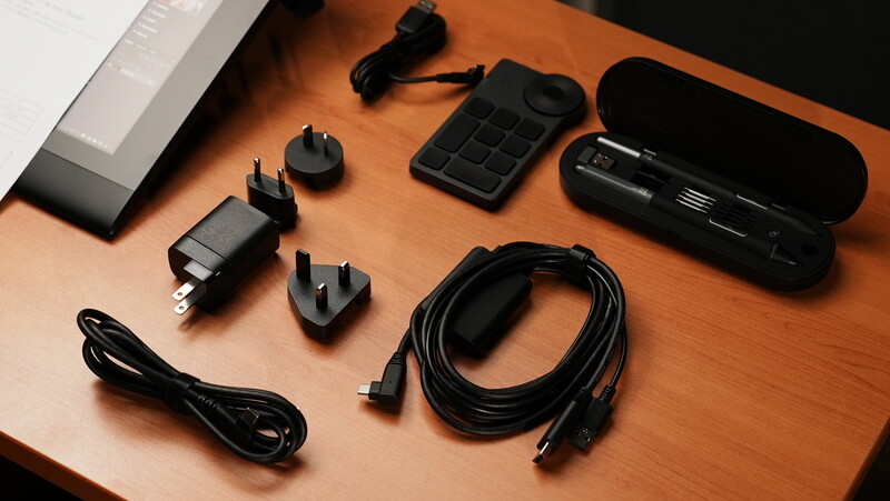 Collection of black audio and tech accessories arranged on a wooden surface.