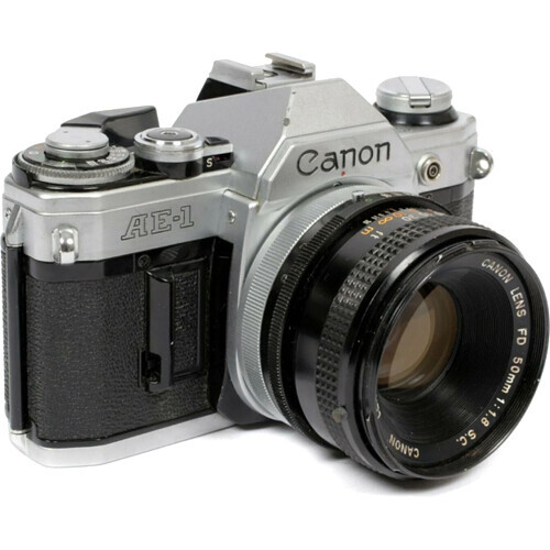 Canon AE-1 35mm film SLR camera with pentaprism viewfinder and standard lens attached.