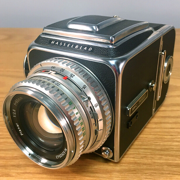 Hasselblad 500C/M medium format camera with Carl Zeiss lens on wooden surface.