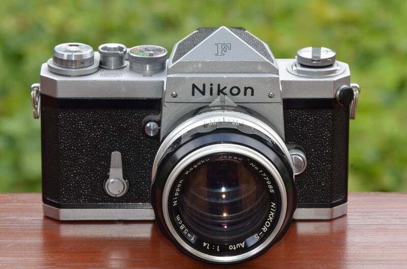 Vintage Nikon rangefinder camera with chrome top plate and black leather body, fitted with a Nikkor lens.
