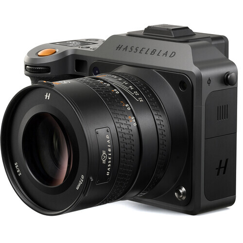 Hasselblad mirrorless camera with attached prime lens against white background.