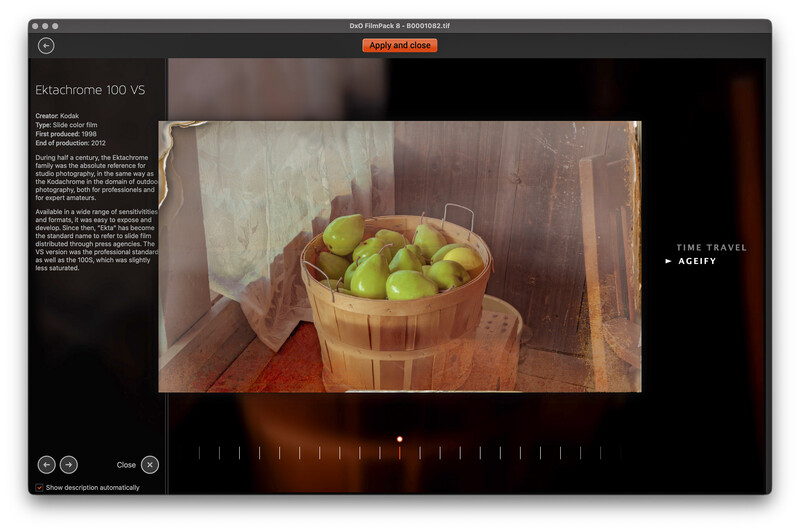 Wooden bushel basket filled with green apples sitting on a wooden floor with warm, diffused window light.
