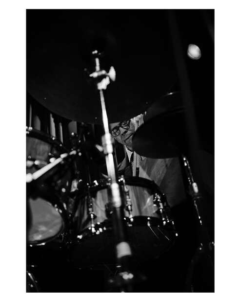 A drummer shot wide open, through his kit.