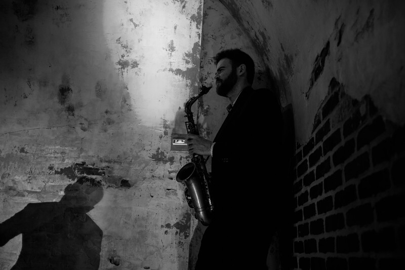 A saxophonist admiring a soloist.