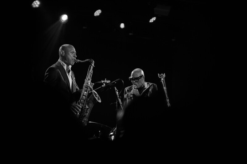 Jazz performers photographed through a crowd.