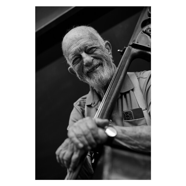 Jazz bassist smiling for the camera.