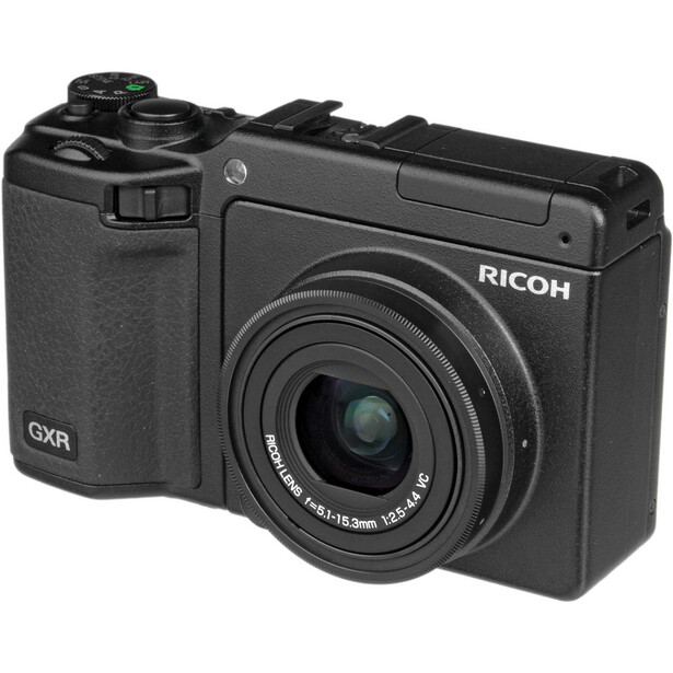Ricoh GXR modular camera system with lens attachment and removable grip module.