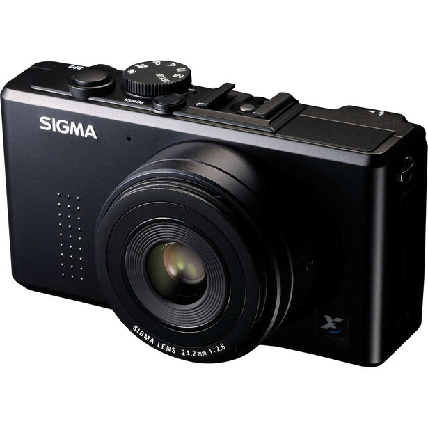 Sigma DP2 Merrill compact camera with fixed lens, shown at three-quarter angle against white background.