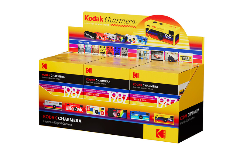 Kodak Charmera display box showing vintage disposable cameras stacked in retail packaging.
