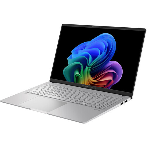 Silver laptop displaying colorful abstract digital artwork with blue, purple, and rainbow gradient swirls.