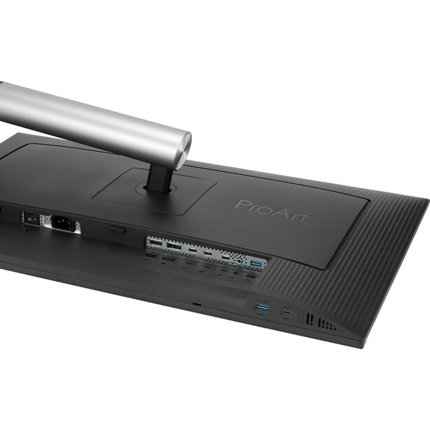 Monitor arm mounted to the back of a black display with cable connections visible.