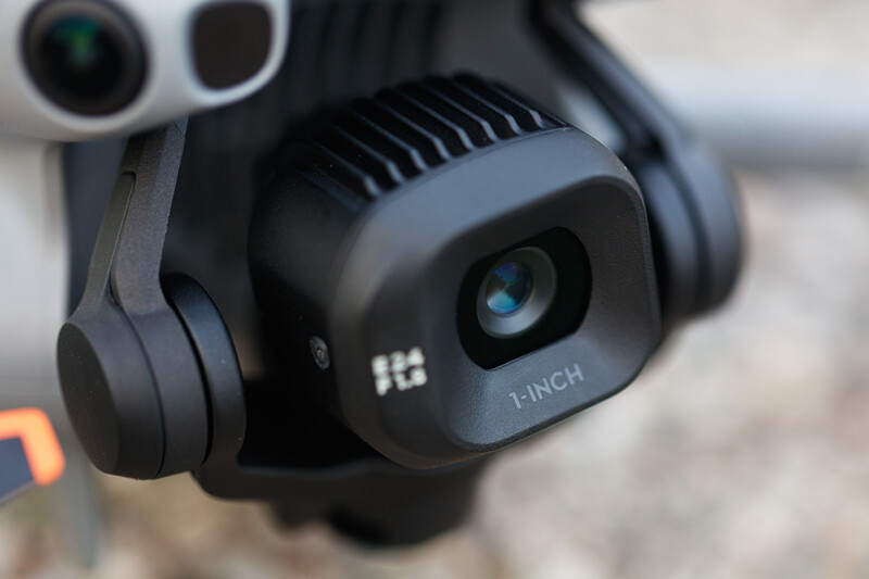 Close-up of a gimbal-mounted camera system with a 1-inch sensor and stabilized lens assembly.