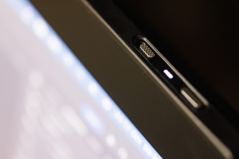 Close-up macro shot of a smartphone's camera lens and edge detail against dark background.
