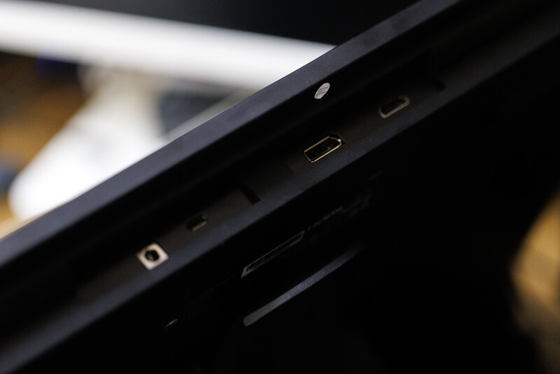 Close-up of a smartphone's side edge showing ports and buttons against a dark background.