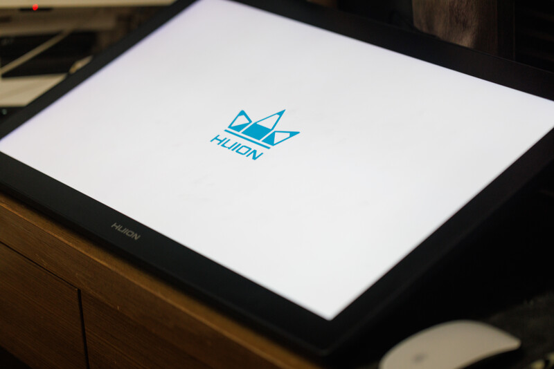Logo for Huen displayed on a tablet screen with white background and blue geometric crown design.