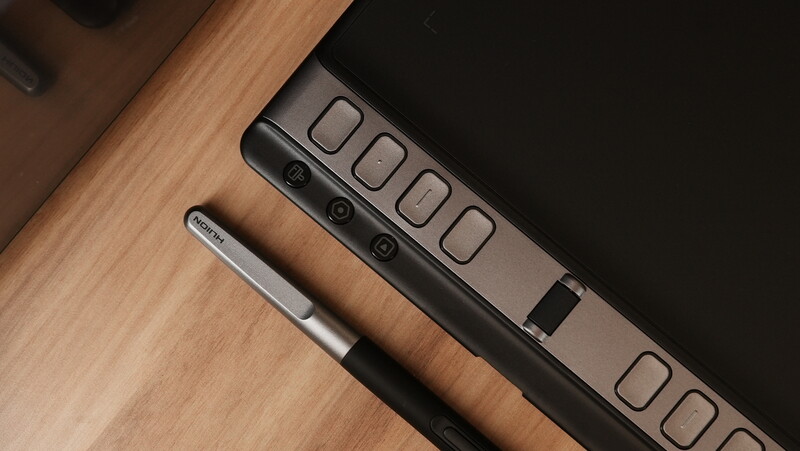 Power strip with multiple outlets and switches on a wooden surface next to a pen.
