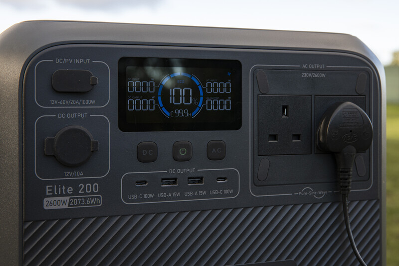 Portable power station with digital display showing 100W output and battery percentage.