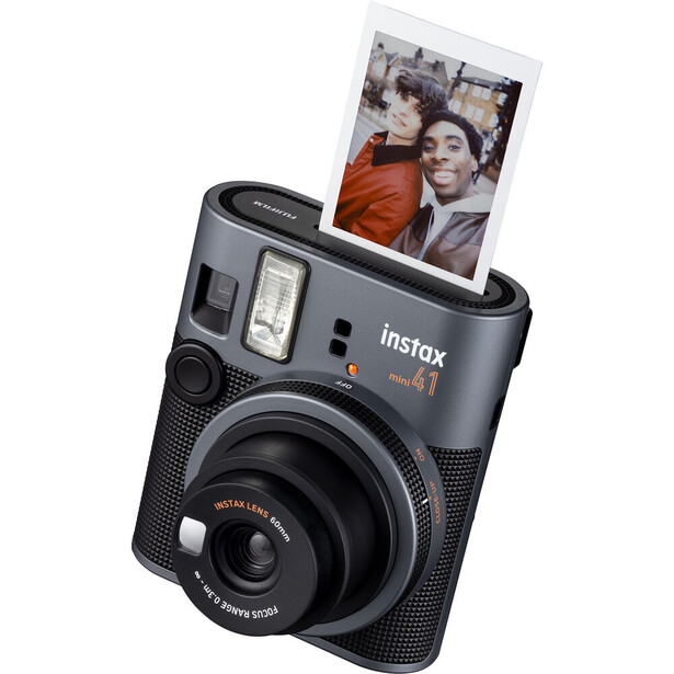 Fujifilm Instax Mini Evo instant camera with ejected photo displayed in top slot.