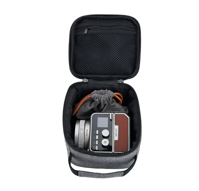 Open camera gear case displaying audio recorder, headphones, and microphone equipment.