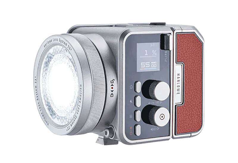 Compact LED light fixture with Fresnel lens attachment, control panel, and red fabric diffusion panel.