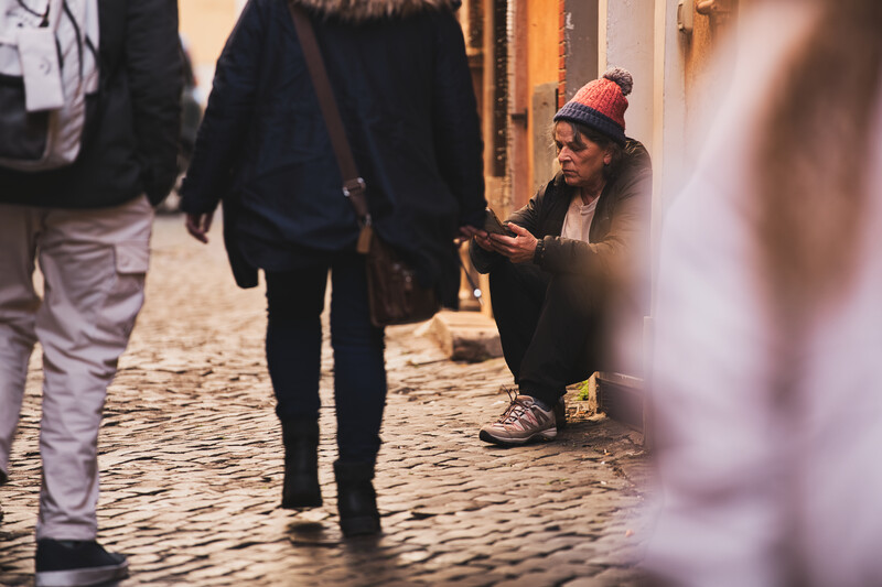 A woman using a cellphone in a busy street.