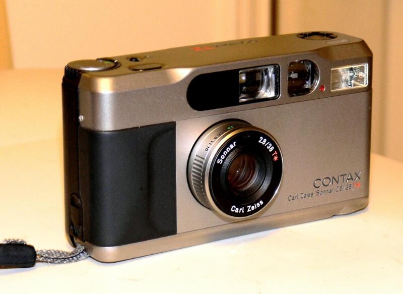 Contax compact film camera with silver and black body and Carl Zeiss lens.