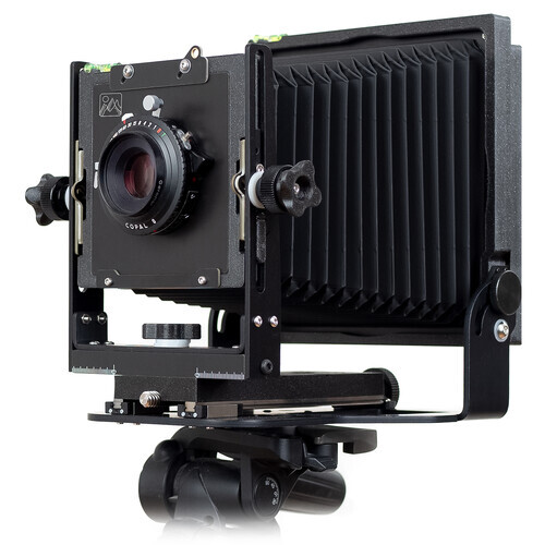 Large format view camera with bellows extended and mounted on a ball head tripod.
