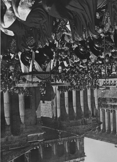 Massive crowd gathered in a classical columned courtyard during what appears to be a significant public gathering or ceremony.