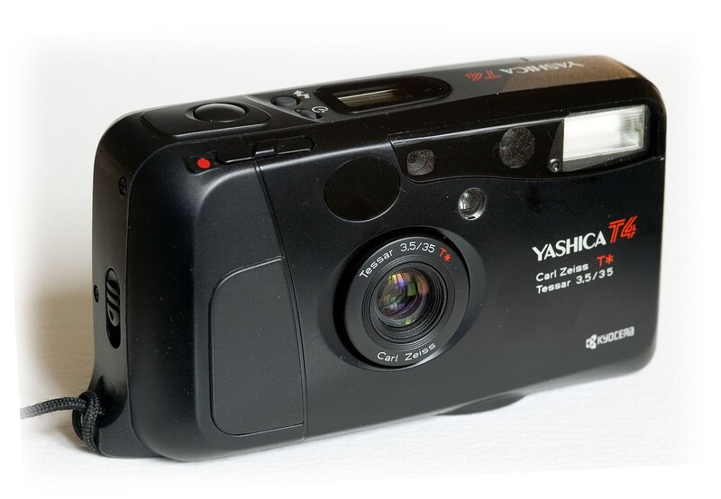 Yashica T4 compact film camera with built-in flash and 35mm lens against white background.